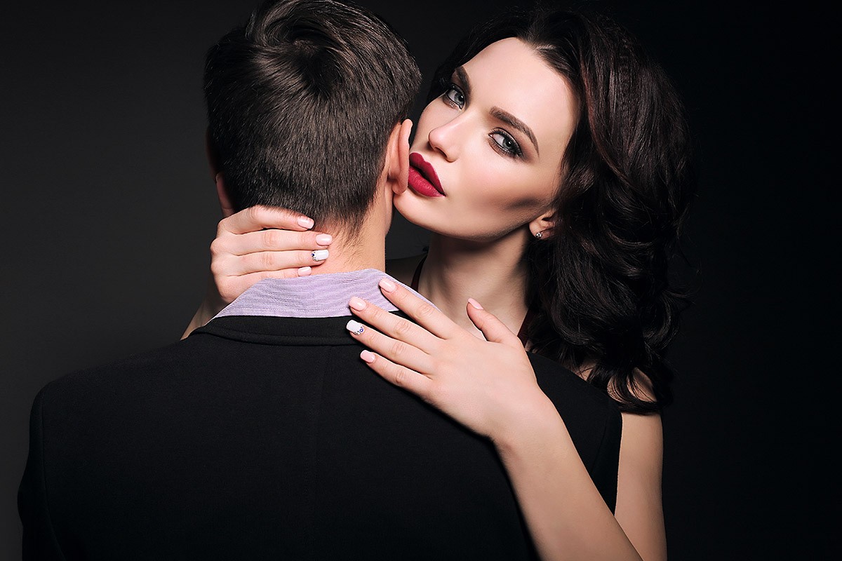 Charming woman hugs her jealous man