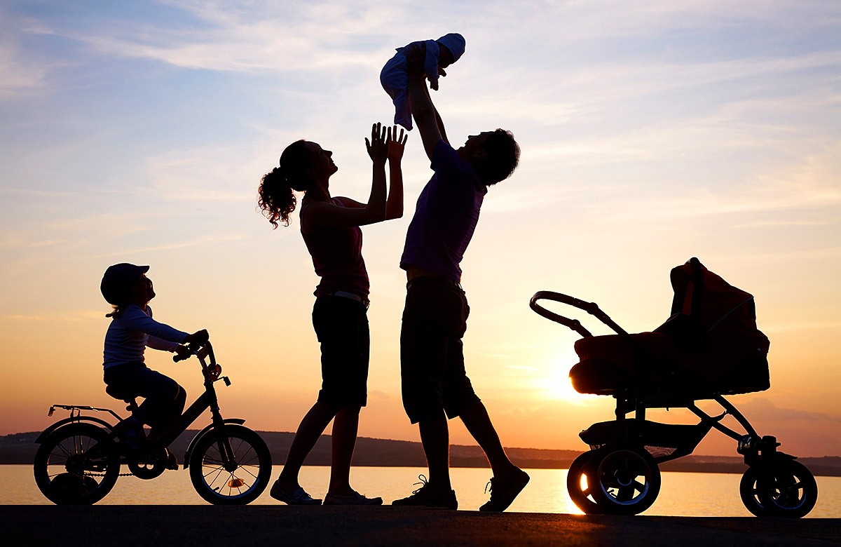 Image of parents with their children at sunset