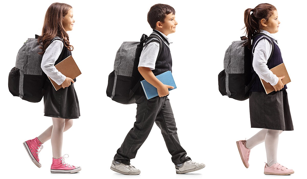 Independent children go to school with books