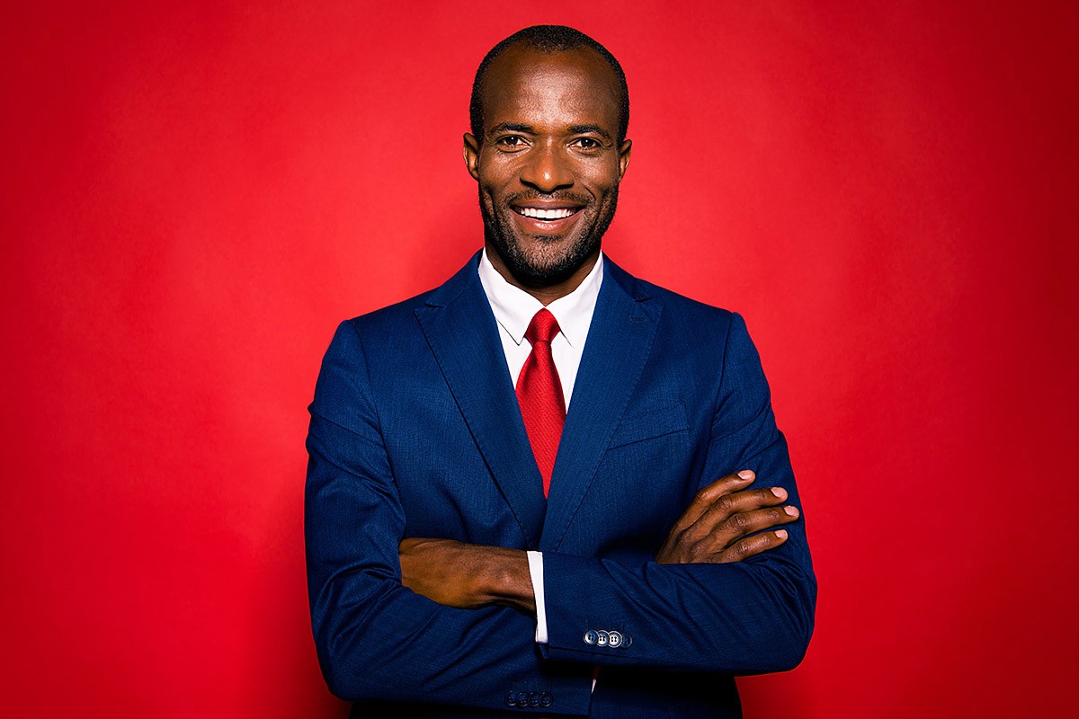 Image of a man in a business suit and red tie