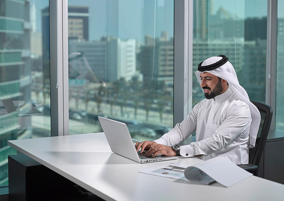 Man works on laptop in office Man works on laptop in office