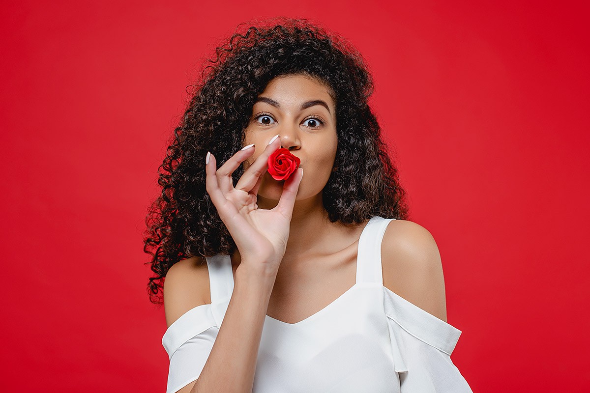 Attractive woman with a red flower
