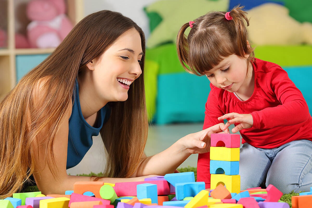Mom and child collect a tower of cubes together