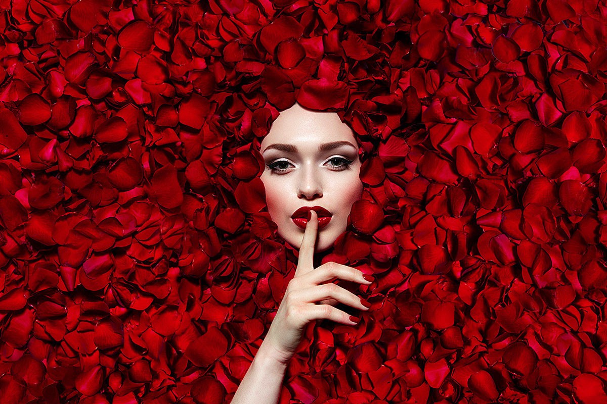 Image of a female face around rose petals