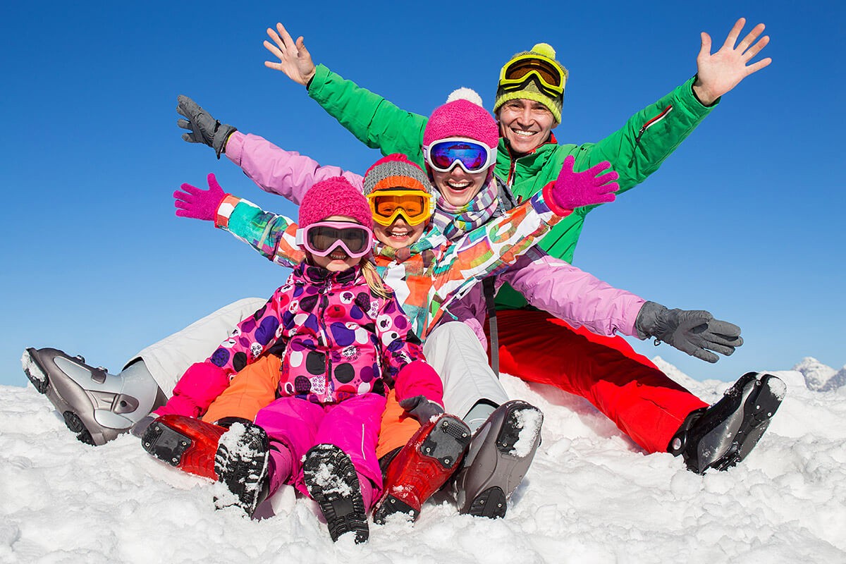 Image of parents and children in ski uniforms