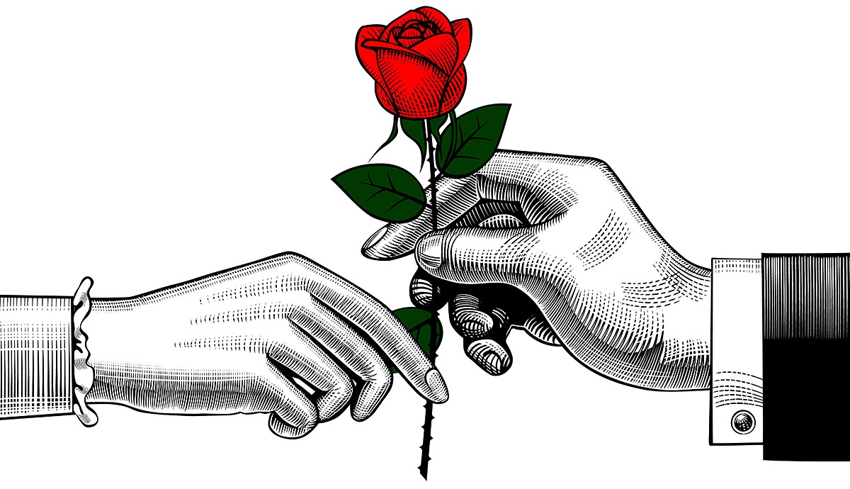 Image of male and female hands with a flower in their hands Image of male and female hands with a flower in their hands