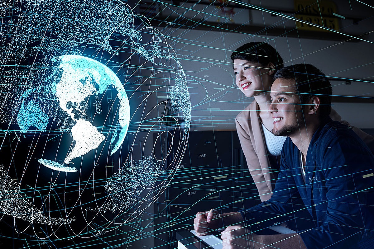 Image of a man and a woman looking at the globe