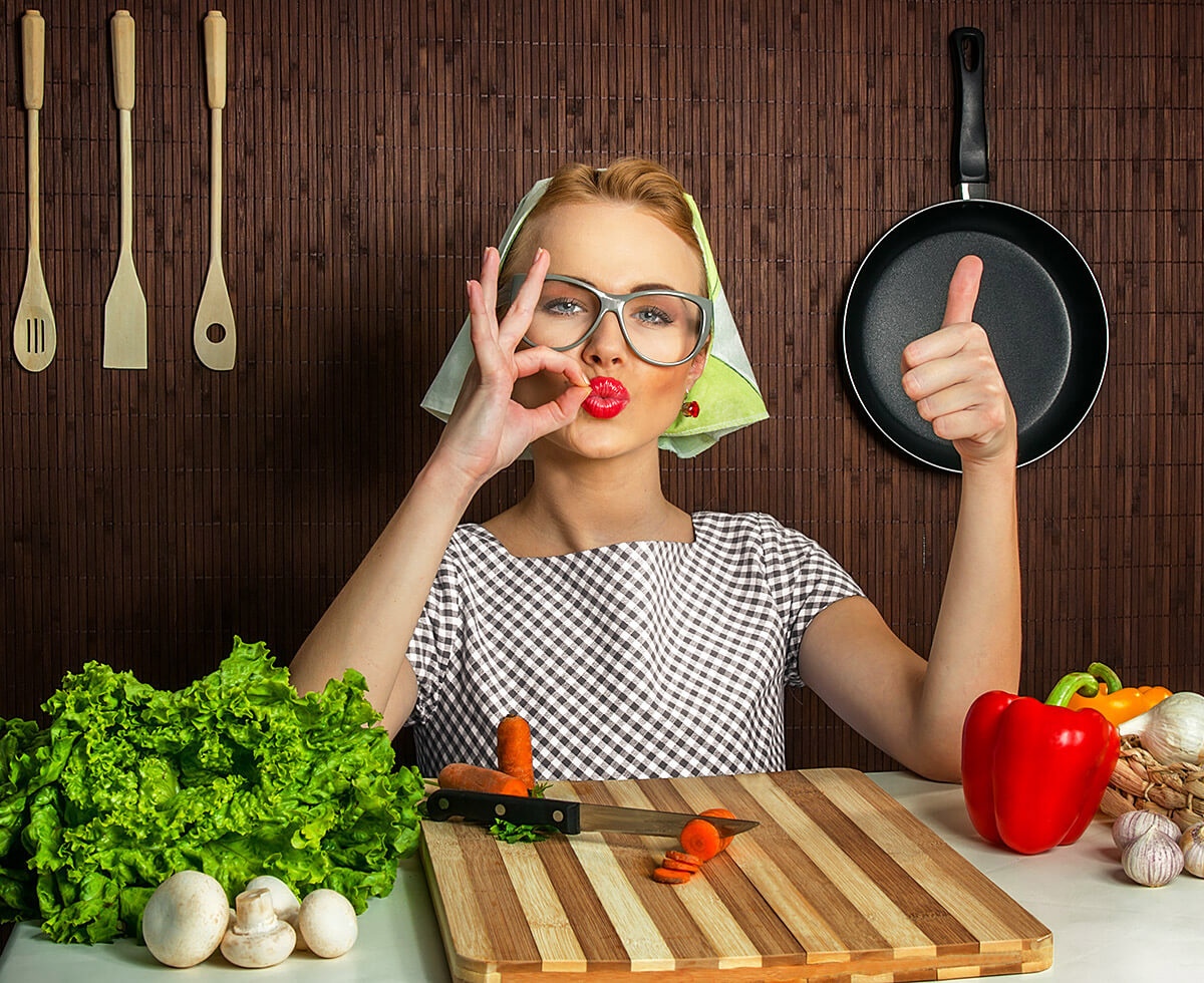 Woman with kitchen utensils shows various hand gestures Woman with kitchen utensils shows various hand gestures