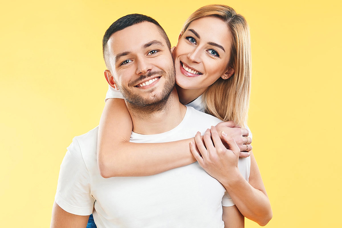 A girl in love gently hugs her boyfriend A girl in love gently hugs her boyfriend