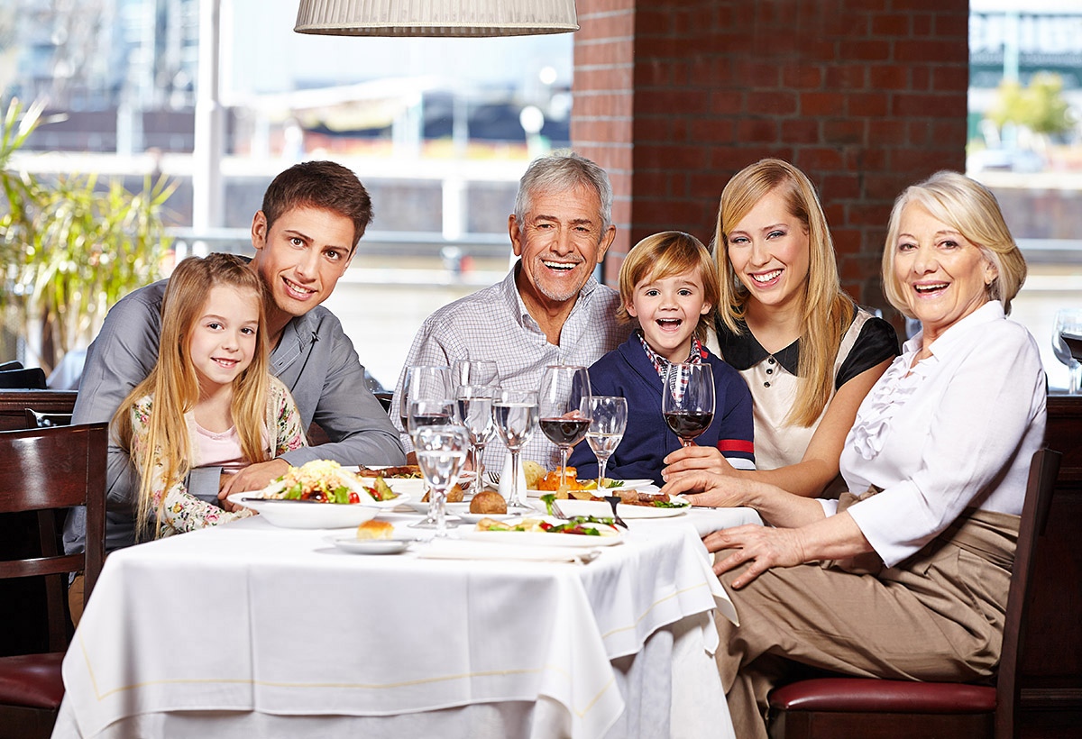 Joyful family at a festive table in a restaurant Joyful family at a festive table in a restaurant