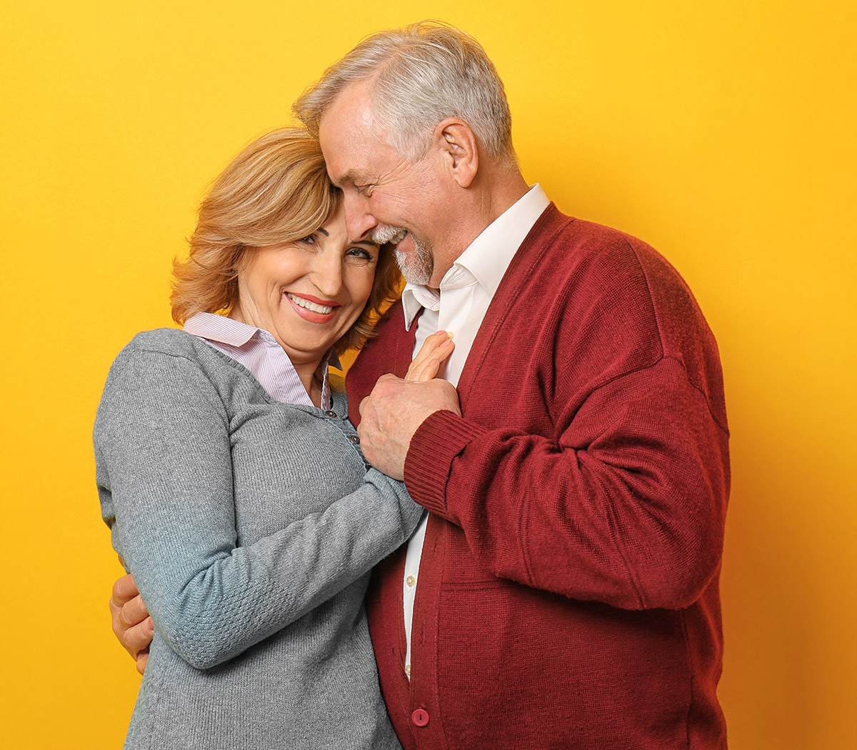Happy elderly man hugs his woman tenderly
