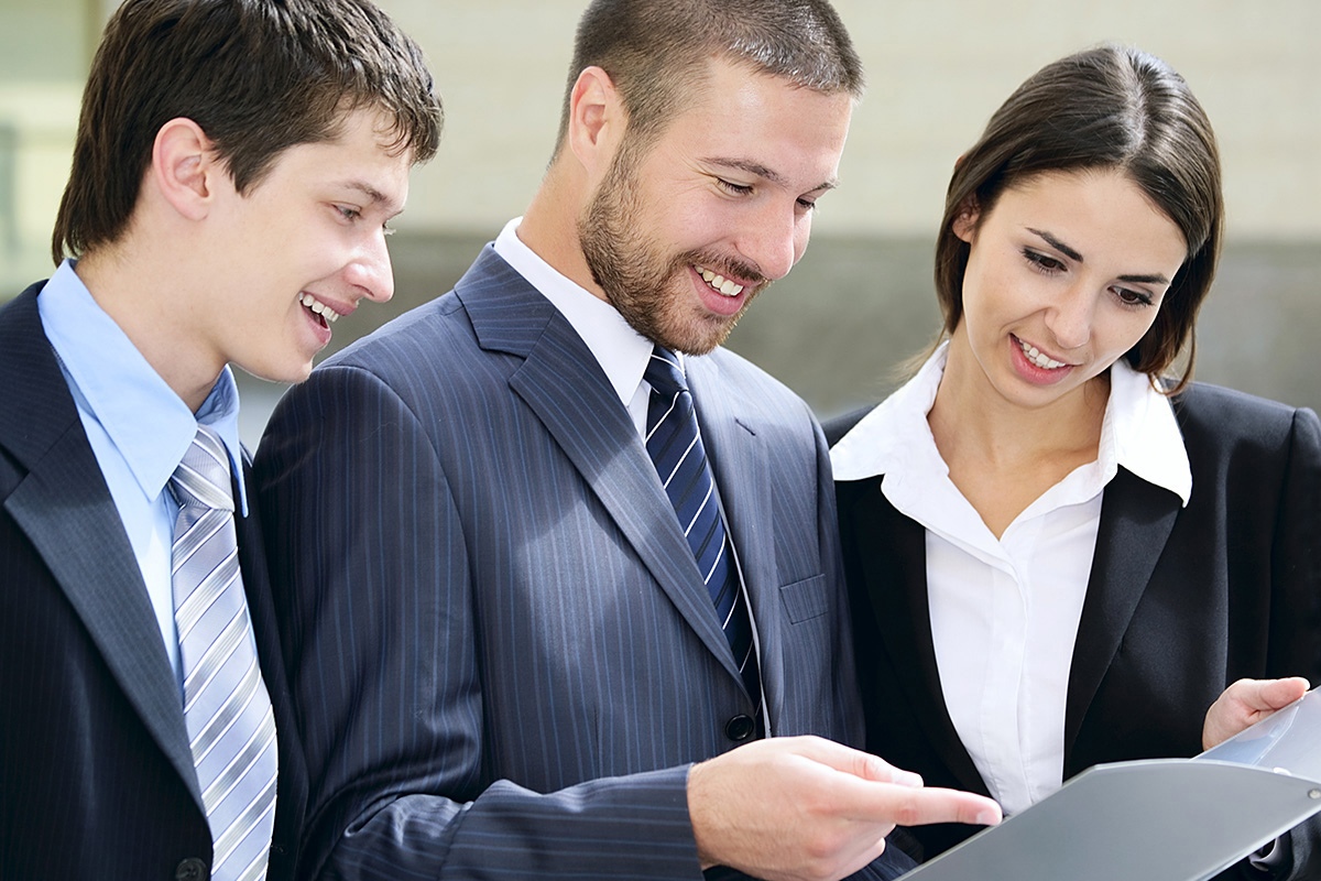 Image of a group of business people looking at documents
