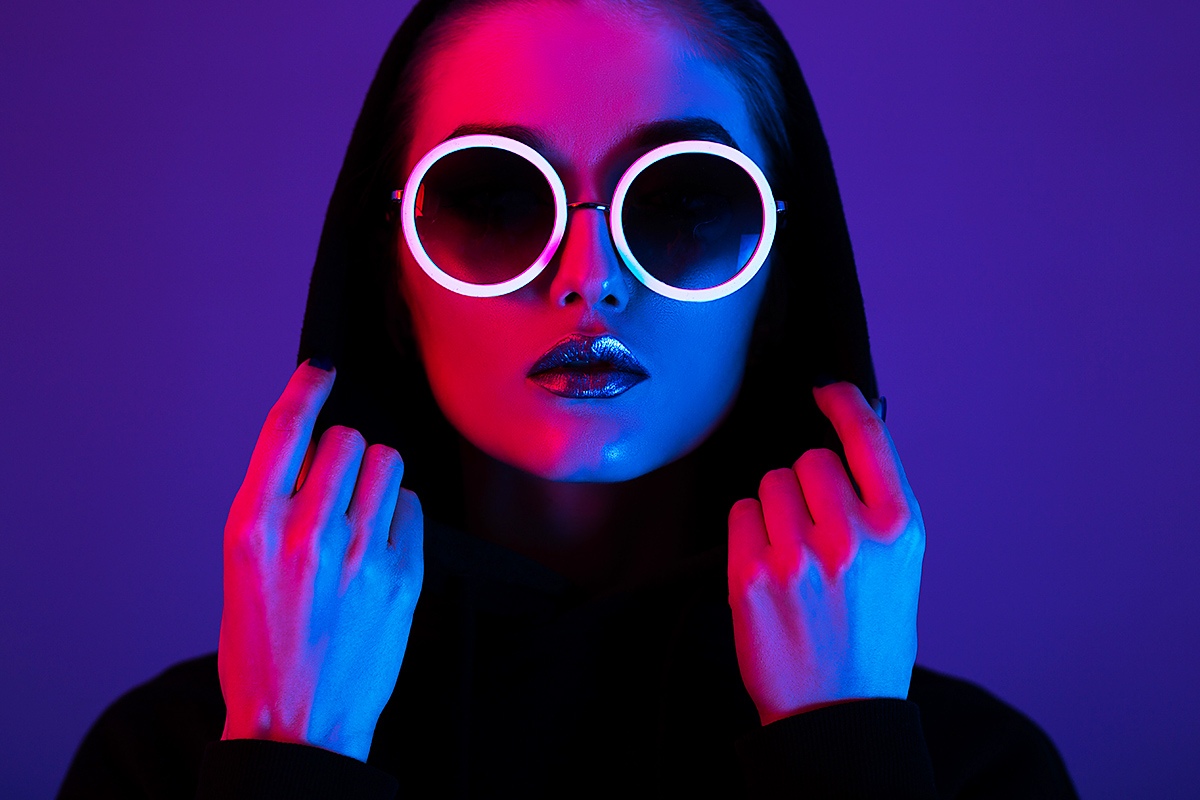 Image of a woman in a hood and sunglasses