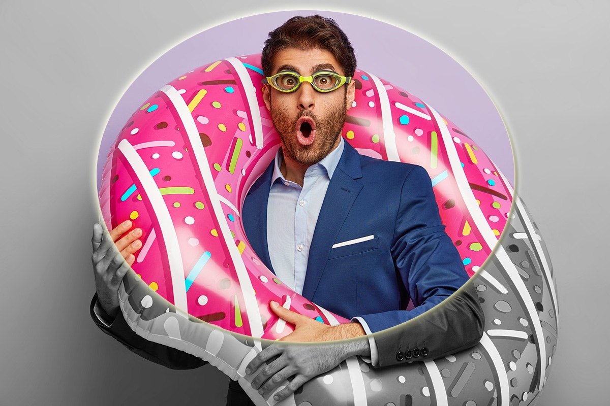 Image of a cheerful man with an inflatable ring