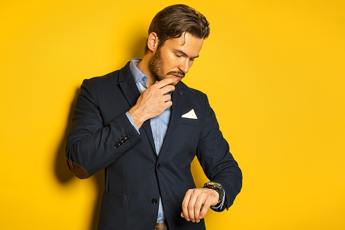 Photo of a business man looking at his watch Photo of a business man looking at his watch
