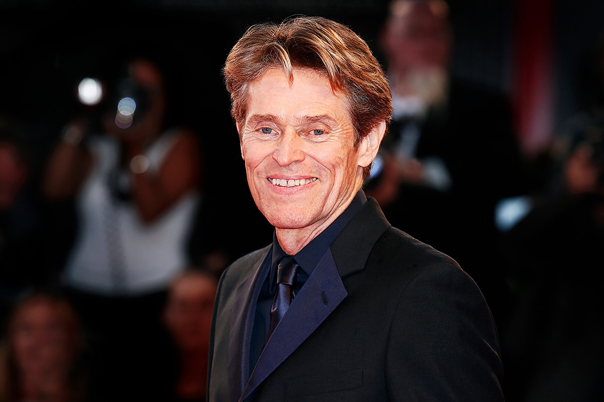 Actor Willem Dafoe smiling sweetly