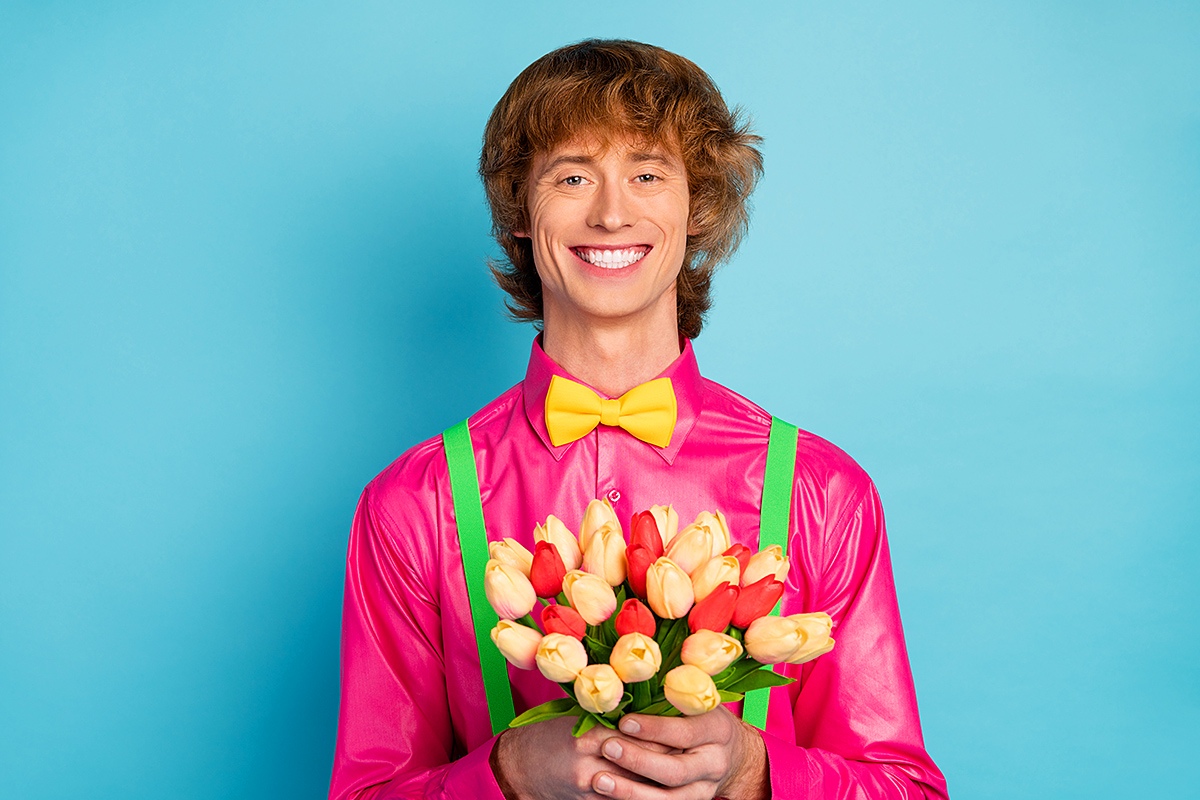 Image of a happy young man with a bouquet of flowers