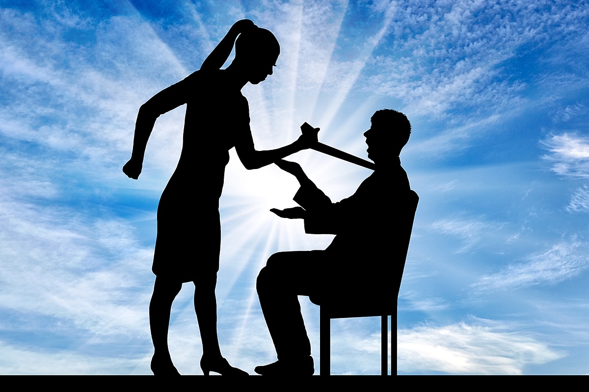 Young woman pulling a man by his tie