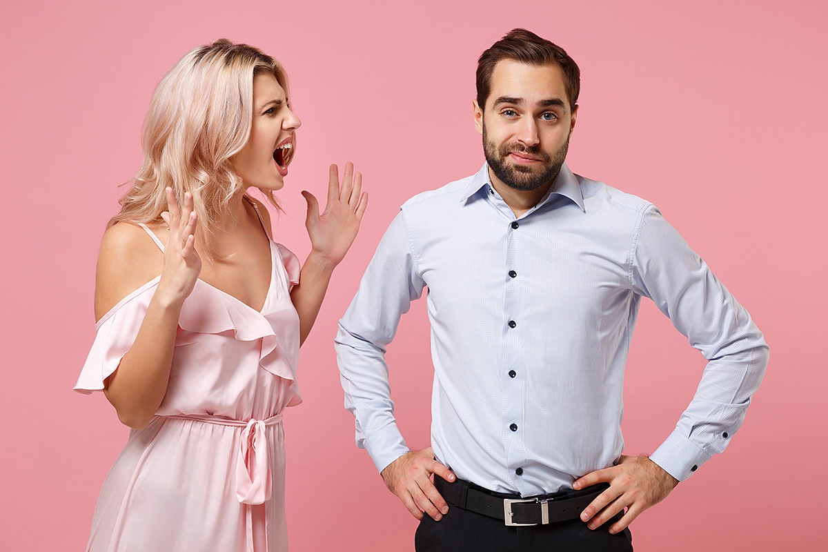 Image of a woman screaming strongly at a man