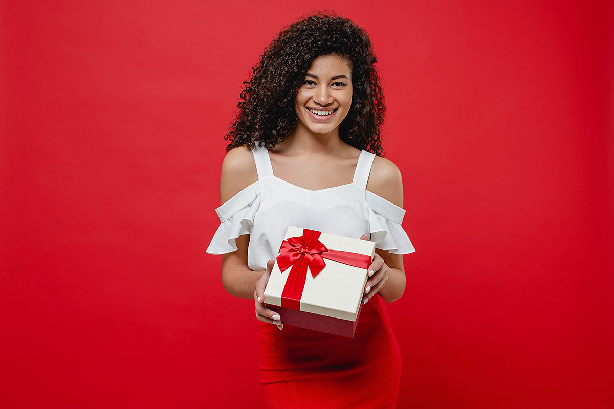 Cute girl with a big gift in her hands