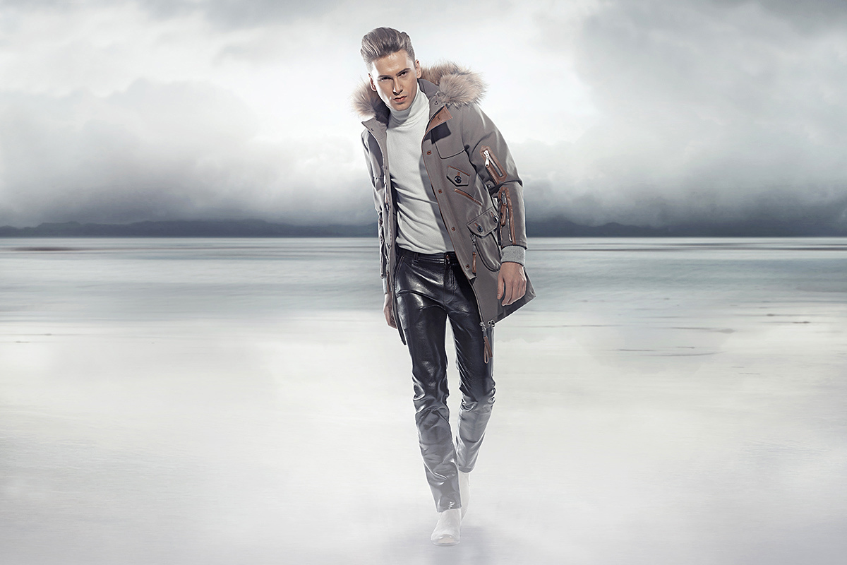 Image of a young man walking in a strong wind