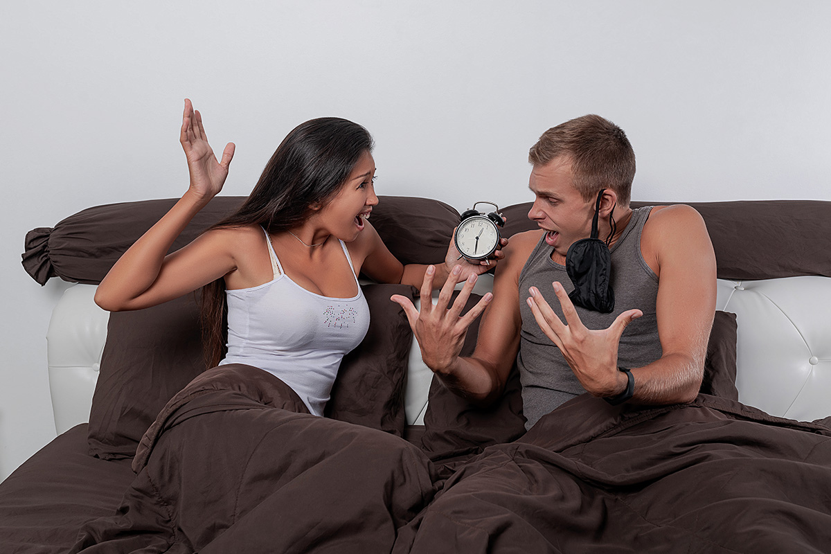 Man and woman have a strong conflict in the morning in bed Man and woman have a strong conflict in the morning in bed