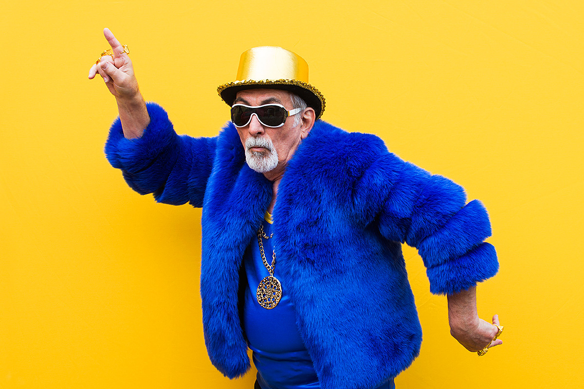 Pretentious elderly man with a gold chain and a blue fur coat