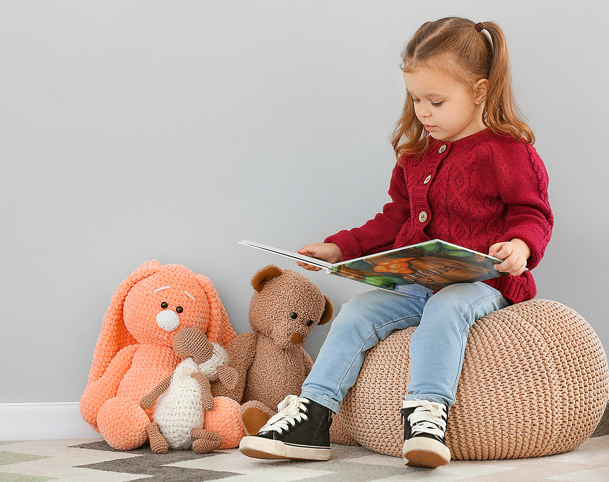 Serious girl carefully reads a book