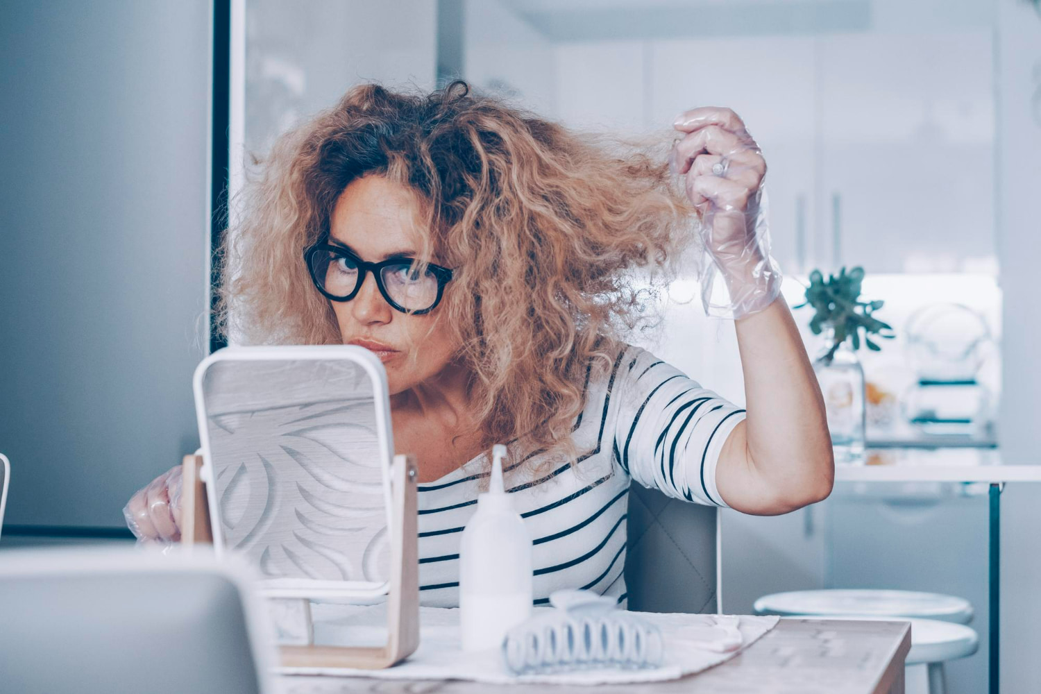A candid, relatable portrait capturing an intimate moment of personal care and self-assessment. A candid, relatable portrait capturing an intimate moment of personal care and self-assessment.