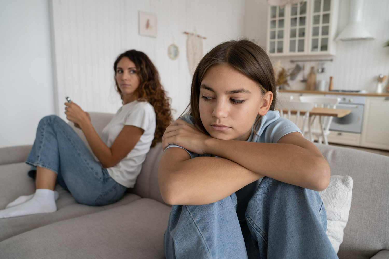 This poignant photograph captures a moment of emotional pain and disconnection between two teenagers.