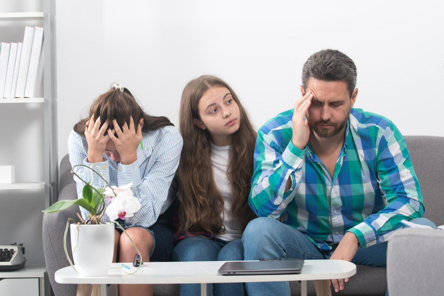 This poignant portrait captures a moment of collective worry and emotional strain within a family unit.