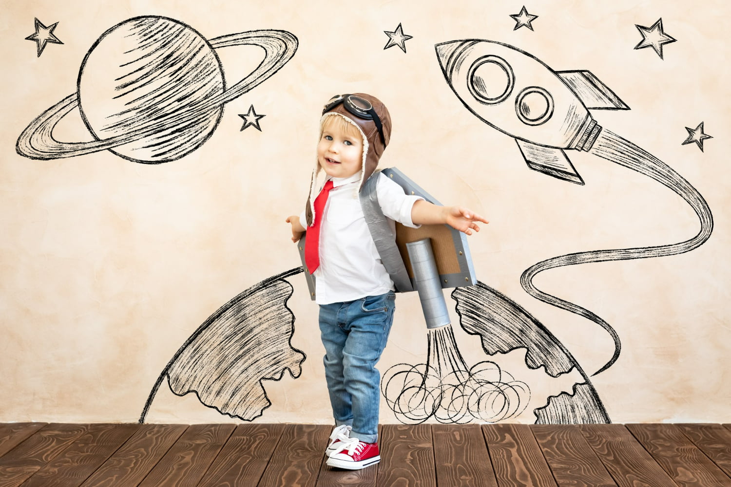 This delightful creative portrait captures a young child dressed as a vintage pilot, ready for an imaginative journey into the cosmos.