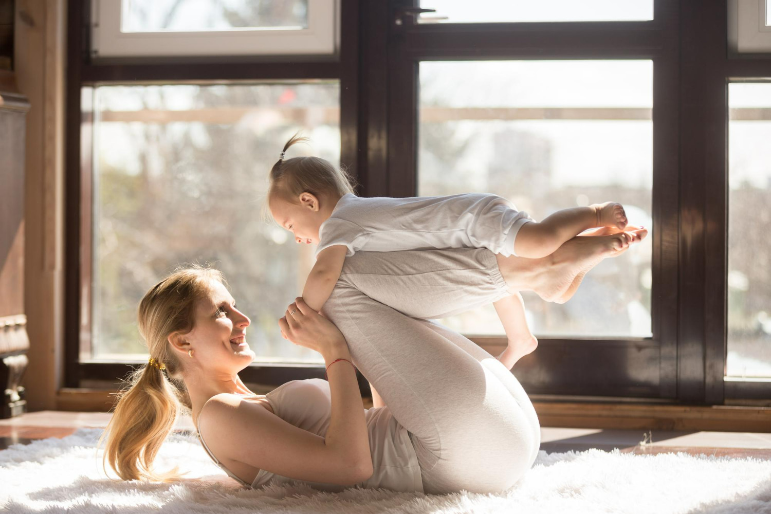 This radiant photograph captures an exquisite moment of pure love, laughter, and connection between a mother and her young child.